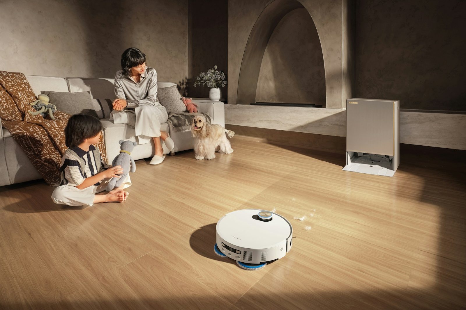 Robot vacuum cleans floor while family relaxes