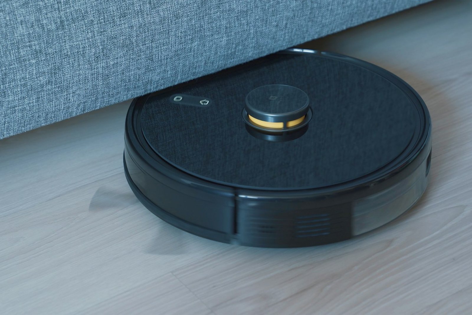 a black robot vacuum on a wooden floor